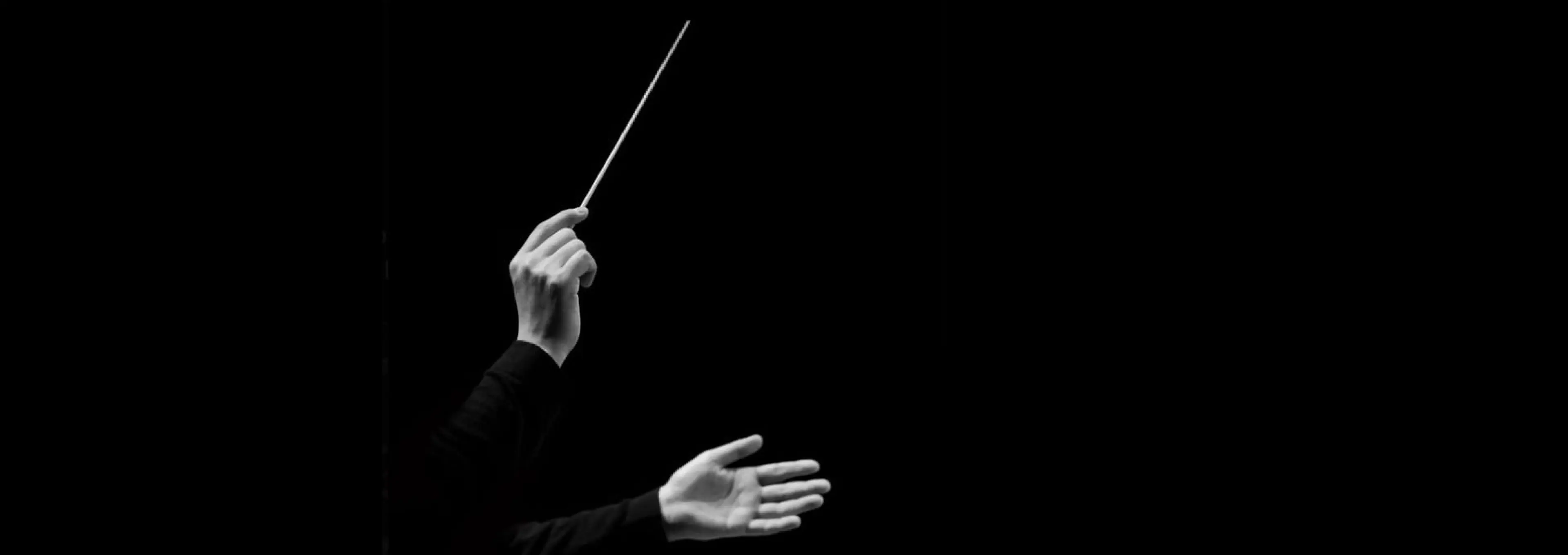 A conductor leading the Chromatica Orchestra